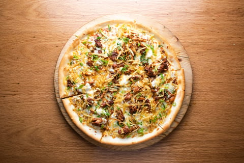 BBQ Chicken Pizza topped with tender chicken, melted cheese, and fresh herbs