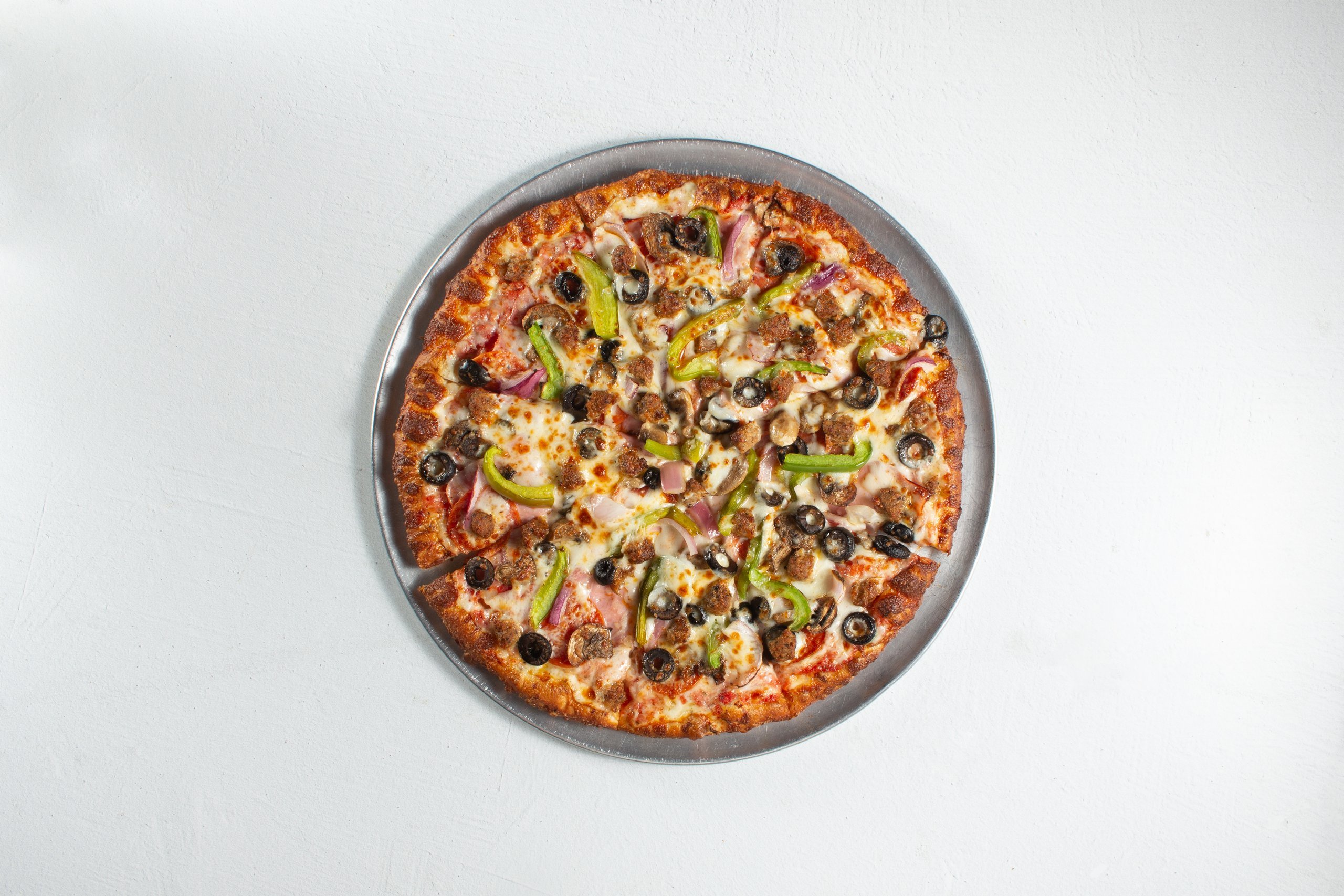 A top down view of a deluxe pizza