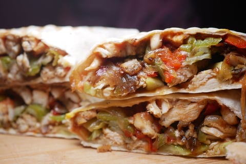 Delicious Grilled Chicken Wrap with Colorful Vegetables and Seasonings