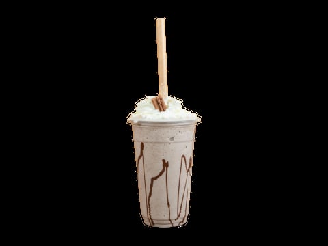Iced coffee drink in clear cup with whipped cream topping and wooden straw on black background