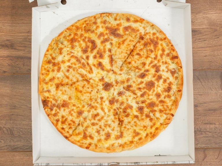 Cheese pizza in white box with slice markings, viewed from above on wooden surface