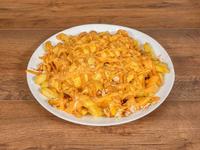 Plate of creamy golden macaroni and cheese on white dish over wooden surface